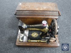 An oak cased vintage Singer hand sewing machine