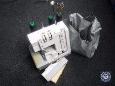 An Elna Lock over locking sewing machine with cover CONDITION REPORT: See