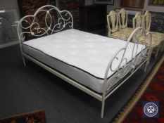 A 4'6 metal bed frame with mattress