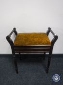 An Edwardian mahogany storage piano stool