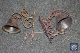 Two cast metal bells on brackets