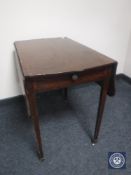 A Victorian mahogany flap-sided table fitted a drawer