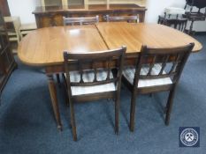 An inlaid mahogany extending dining table with leaf together with four chairs