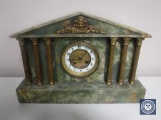 A Victorian onyx mantel clock with brass column supports