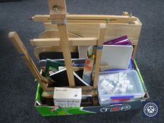 A box containing artist's supplies and easels