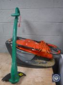 A Flymo Easiglide 300 electric lawn mower with box together with a garden strimmer