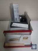 A box containing a collection of pens including Parker,