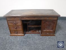 A carved oriental style correspondence rack fitted three drawers and a cupboard