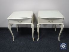 A pair of cream and gilt bedside stands fitted a drawer