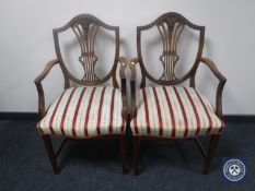 A pair of mahogany shield back armchairs upholstered in striped fabric