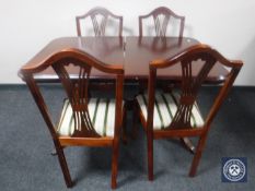 A mahogany Regency style extending dining table together with four chairs