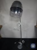 A 20th century lightweight floor standing hair dryer converted into a floor lamp together with an