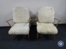 A pair of mid 20th century Ercol elm armchair with cushions CONDITION REPORT: Spring