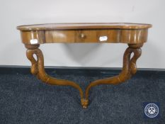 A walnut wall shelf fitted a drawer on swan neck supports