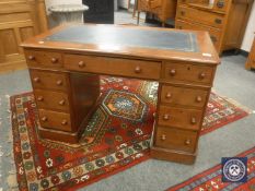 A Victorian mahogany child's twin pedestal writing desk with tooled leather inset panel,