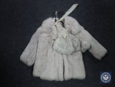 An early 20th century child's fur coat with hat