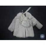 An early 20th century child's fur coat with hat