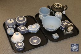 Two trays containing a collection of Wedgwood black and blue Jasperware including mantel clock,