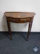 A shaped mahogany hall table on tapered legs