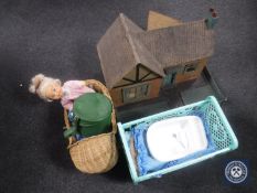 A mid 20th century cottage doll's house together with a wicker and plastic doll's crib containing