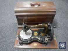 An early 20th century cased Jones hand sewing machine
