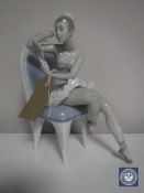 A Lladro figure of a ballerina seated on a chair holding a mirror CONDITION REPORT: