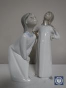 Two Lladro figures; Girl with hands on hips and Girl blowing kiss,