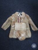An early 20th century child's fur coat with matching hat,