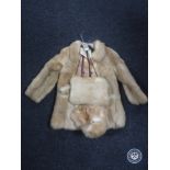 An early 20th century child's fur coat with matching hat,