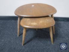 A nest of two Ercol elm pebble tables