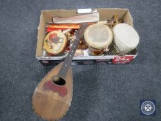 A box of assorted musical instruments including an Alfredo Albertin bowl-back mandolin, hand drums,