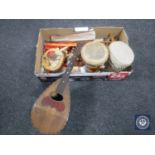 A box of assorted musical instruments including an Alfredo Albertin bowl-back mandolin, hand drums,