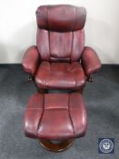 A red leather electric swivel relaxer chair with stool