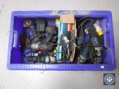A box containing assorted power tools including Makita angle grinders,