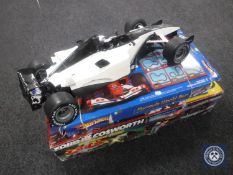 A boxed Ford RS Cosworth Scalextric set together with a Hotwheels Formula World Tour and a battery
