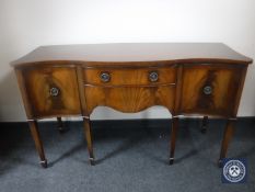 An inlaid mahogany serpentine front sideboard