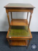 A yew wood two tier coffee table with tooled leather inset panel,