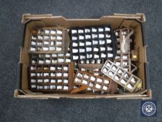 A box containing a large quantity of metal and china thimbles on racks