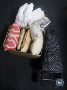 A trolley containing cushions together with two further boxes containing table linen and cushions