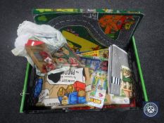 A box containing 20th century children's toys including jigsaw puzzles,