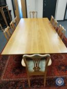 A contemporary 9' oak dining table on cast iron X-frame support,