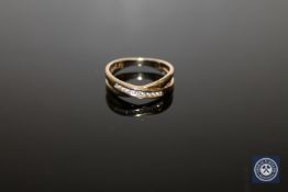 A 9ct gold diamond crossover ring,