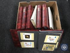 A box containing eight albums of Royal Mail postcards