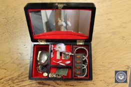 A musical jewellery box containing coins, silver filigree brooch, silver and amethyst pendant,