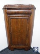 An antique mahogany corner cabinet fitted with a drawer