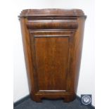 An antique mahogany corner cabinet fitted with a drawer