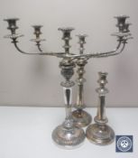 A pair of Sheffield plated candelabrum and single candlestick (3)