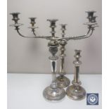 A pair of Sheffield plated candelabrum and single candlestick (3)