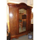 A continental mahogany triple door wardrobe