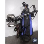 A golf trolley with bag containing Hippo clubs and pair of golf shoes size 8.5.
